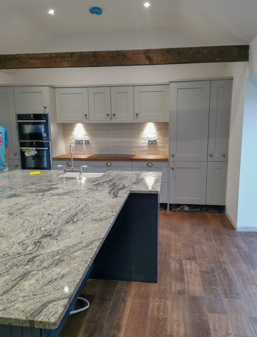Granite topped island with a navy base and oak worktops